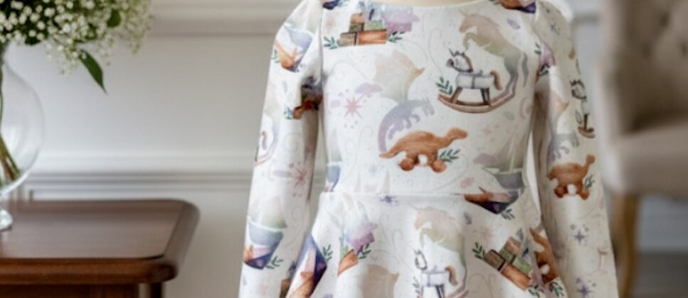 Baby girl wearing floral poppy dress from Rabbit and Hare collection