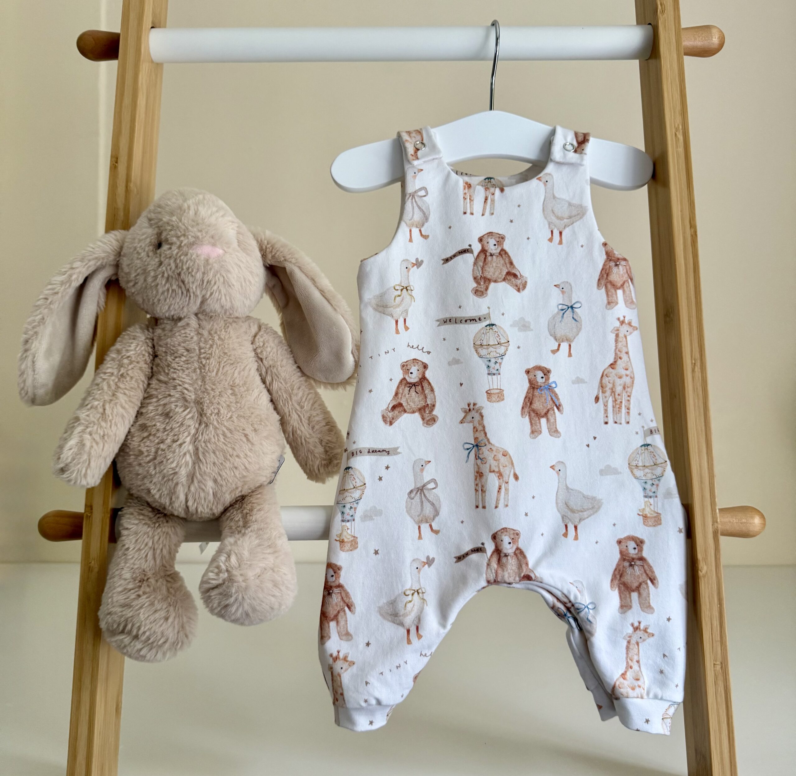 Baby wearing sky blue organic cotton romper from Rabbit and Hare